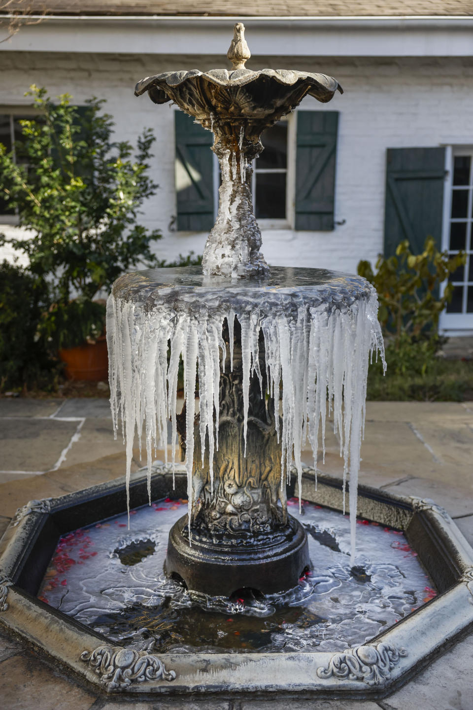 A fountain freezes at the Historic BK House & Gardens during freezing weather in New Orleans, Wednesday, Jan. 17, 2024. (Sophia Germer/The Times-Picayune/The New Orleans Advocate via AP)