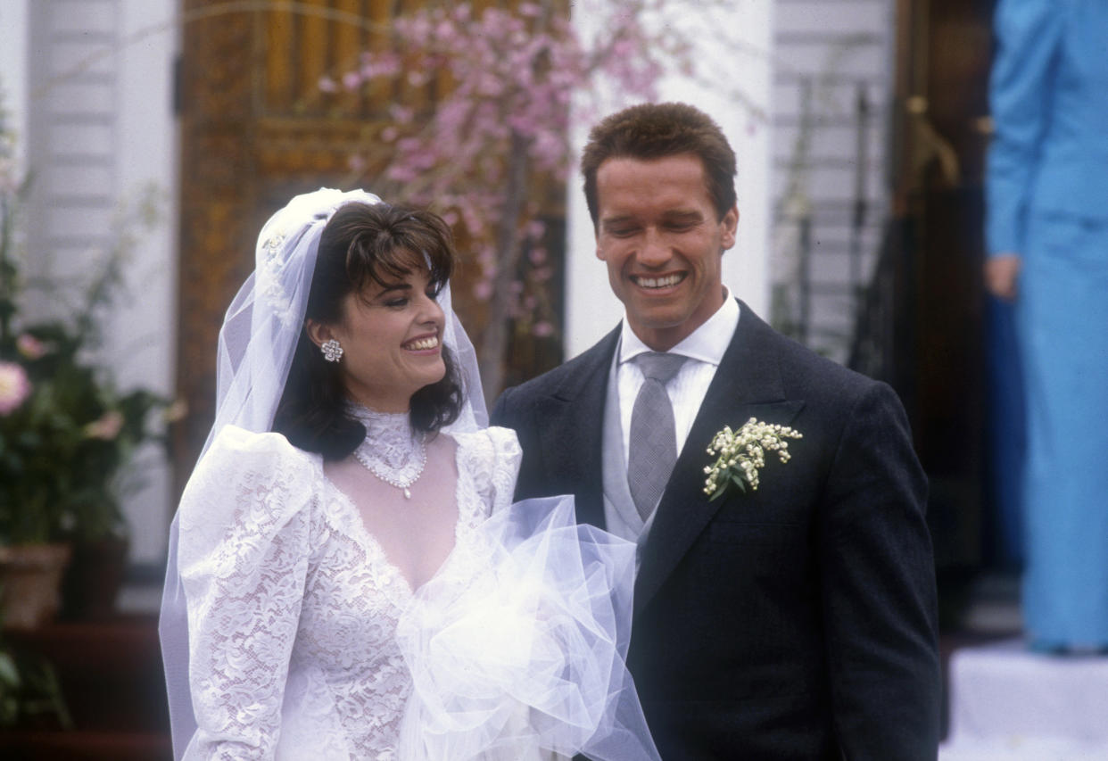HYANNIS, MA - APRIL 26: Actor Arnold Schwarzenegger with his new wife Maria Shriver outside St. Francis Xavier Church after their wedding on April 26, 1986 in Hyannis, Massachusetts. (Photo by Peter Carrette Archive/Getty Images)