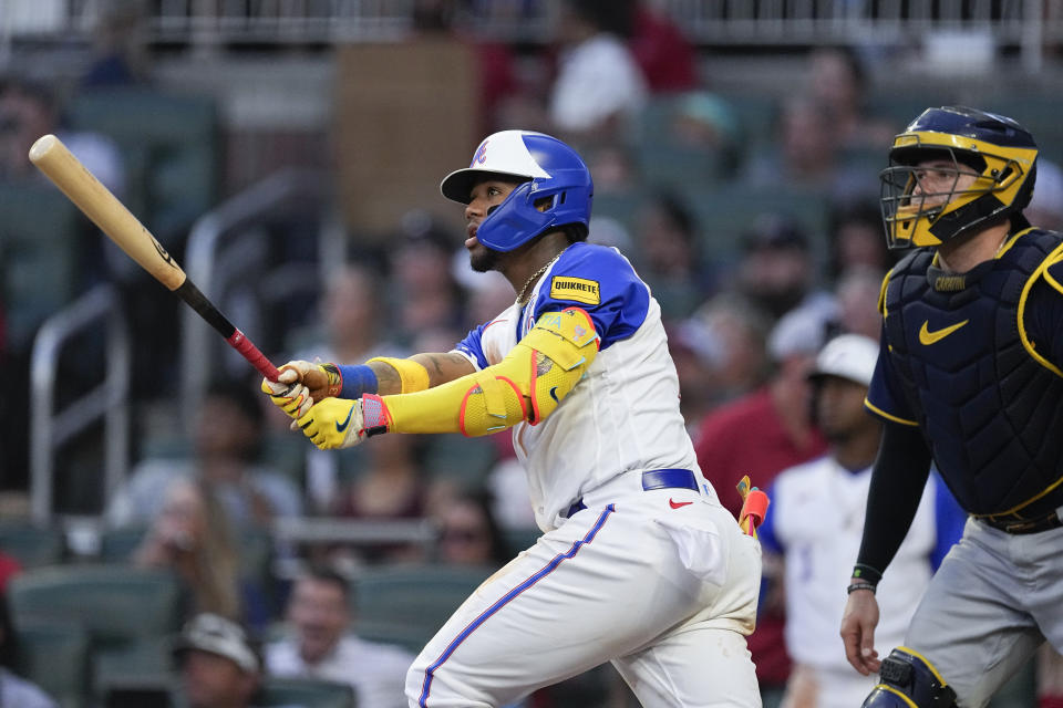 Atlanta Braves' Ronald Acuna Jr. (13) and Milwaukee Brewers catcher Victor Caratini (7) watch Acuna's two-run home run during the fourth inning of a baseball game Saturday, July 29, 2023, in Atlanta. (AP Photo/John Bazemore)