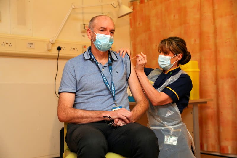 FILE PHOTO: Professor Andrew Pollard receives the Oxford University/AstraZeneca COVID-19 vaccine at the Churchill Hospital in Oxford