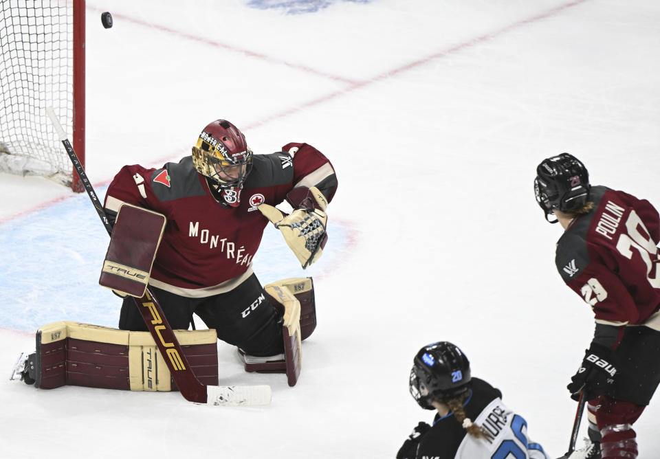 Toronto's Sarah Nurse (20) scores against Montreal goaltender Ann-RenEe Desbiens as Montreal's Marie-Philip Poulin (29) looks on during the overtime period of a PWHL hockey game at the Bell Centre in Montreal, Saturday, April 20, 2024.(Graham Hughes/The Canadian Press via AP)