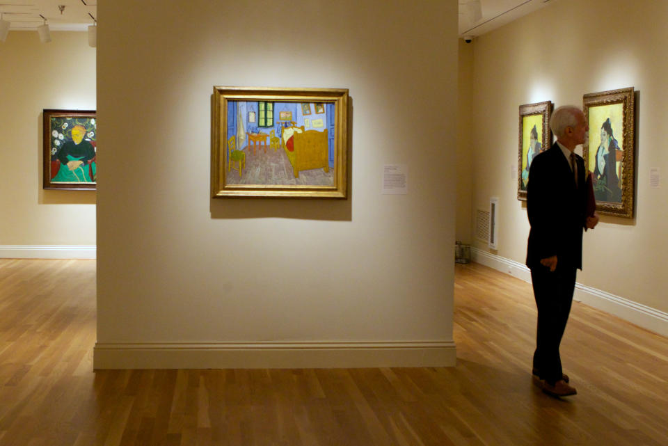 In this Oct. 8, 2013 photo, a member of the media walks through an exhibit of Vincent van Gogh on display at The Phillips Collection in Washington. In the midst of the shutdown of federally funded museums, the private Phillips Collection is launching the first major exhibition of Vincent van Gogh’s artwork in Washington in 15 years. (AP Photo/Molly Riley)