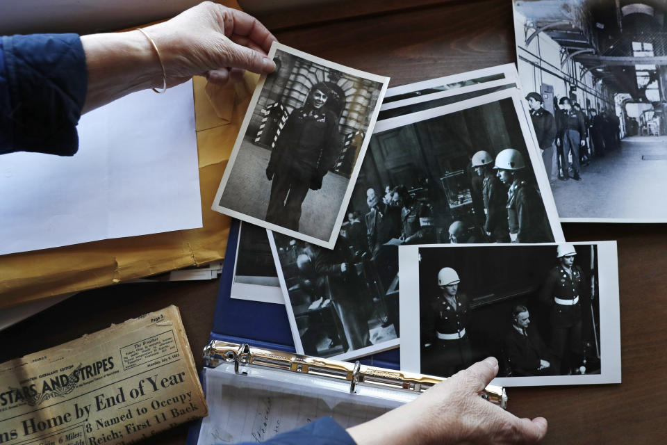 Emily DiPalma Aho looks over photographs and memorabilia of her father, Emilio DiPalma, a World War II veteran, at her home in Jaffrey, N.H., Wednesday, May 13, 2020. Emilio, who as a 19-year-old U.S. Army infantryman stood guard at the Nuremberg Nazi war crimes trials, died last month at the age of 93 after contracting the coronavirus at Holyoke Soldiers' Home in Massachusetts. (AP Photo/Charles Krupa)