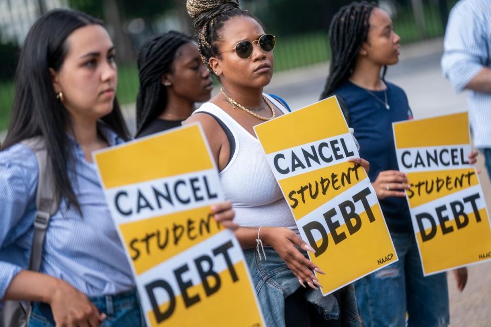 Student loan debt advocates rally in Washington DC following the Biden administration’s plan to cancel some federal student loan debt on 25 August (EPA)