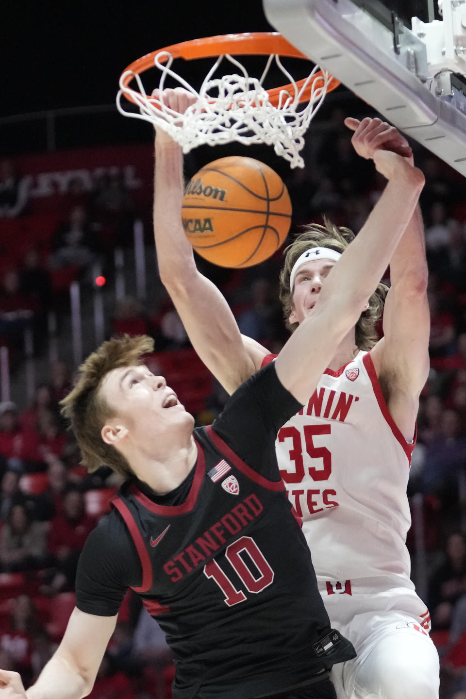 Utah center Branden Carlson (35) dunks against Stanford forward Max Murrell (10) during the second half of an NCAA college basketball game Thursday, Feb. 2, 2023, in Salt Lake City. (AP Photo/Rick Bowmer)