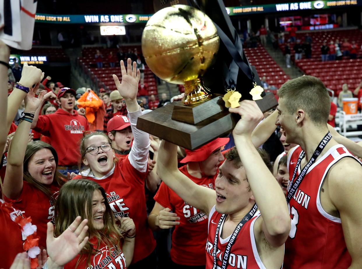 Brillion's Caeden Holly hoists the state championship trophy after the Lions defeated West Salem during their WIAA Division 3 state championship boys basketball game March 18, 2023, at the Kohl Center in Madison.