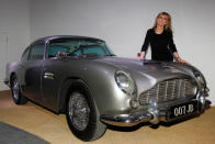 Actress and former "Bond Girl", Britt Ekland, poses for photographers with an Aston Martin DB5 from the James Bond film "Goldfinger" at the opening of the "Bond in Motion: 50 Vehicles 50 Years" exhibition at the National Motor Museum in Beaulieu, southern England January 15, 2012. REUTERS/Suzanne Plunkett