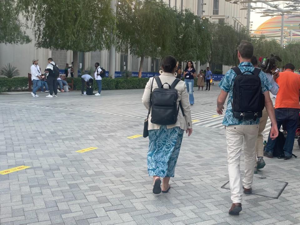 Tina Stege and a colleague make their way across the vast Cop28 venue (The Independent/Louise Boyle)