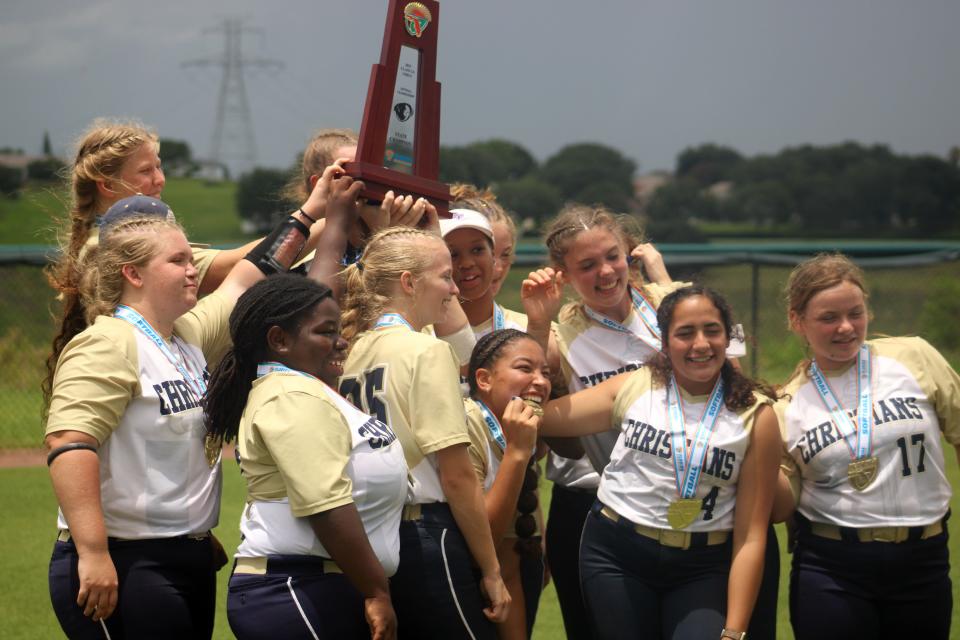 University Christian players celebrate after winning the FHSAA Class 2A high school softball championship against Fort Myers Evangelical Christian.