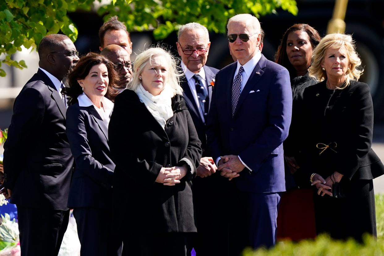 President Joe Biden and first lady Jill Biden meet with officials including, Buffalo Mayor Byron Brown, left, New York Gov. Kathy Hochul, Sen. Kirsten Gillibrand, D-N.Y., Senate Majority Leader Chuck Schumer of N.Y., and New York Attorney General Letitia James, as they visit the scene of a shooting at a supermarket to pay respects and speak to families of the victims of Saturday's shooting in Buffalo, N.Y., Tuesday, May 17, 2022. (AP Photo/Matt Rourke)