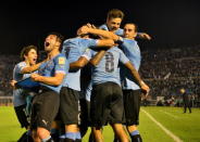 Uruguay's players celebrate after scoring a goal against Colombia during their 2018 World Cup qualifying soccer match at the Centenario stadium in Montevideo, Uruguay, October 13, 2015. REUTERS/Carlos Pazos