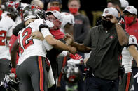 Tampa Bay Buccaneers quarterback Tom Brady (12) hugs head coach Bruce Arians on the sidelines during the second half of an NFL divisional round playoff football game against the New Orleans Saints, Sunday, Jan. 17, 2021, in New Orleans. The Buccaneers won 30-20. (AP Photo/Butch Dill)