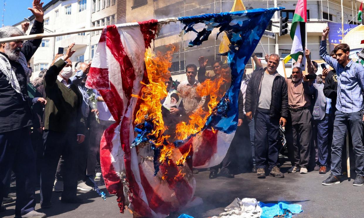 <span>Protesters in Iran burn the US and Israeli flags during the funeral for the seven Islamic Revolutionary Guards killed in Israel’s attack in Damascus, Syria, on 1 April.</span><span>Photograph: AFP/Getty Images</span>