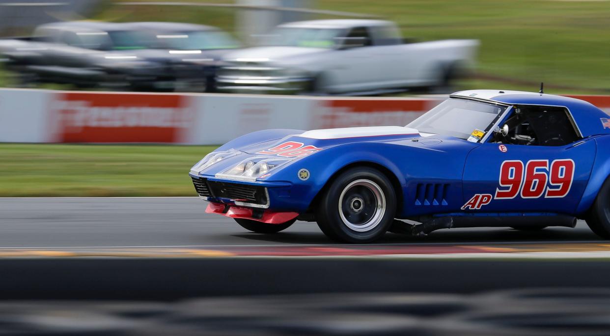 A blue late 1960s Chevrolet Corvette is a blur out of turn 14 during the Ariens Art on Wheels vintage weekend, Saturday, September 16, 2023, at Road America near Plymouth, Wis.