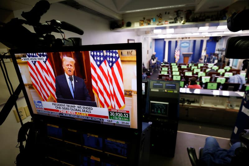 Trump makes remarks on TV monitor from White House Briefing Room during his last day in office, in Washington