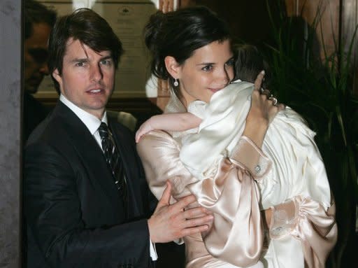 Actors Tom Cruise (L) and Katie Holmes (R), holding their daughter Suri, leave a restaurant in central Rome days before their wedding in 2006. The couple announced Friday they were calling it quits after five years of marriage, ending an unexpected love story dogged by tabloid rumors