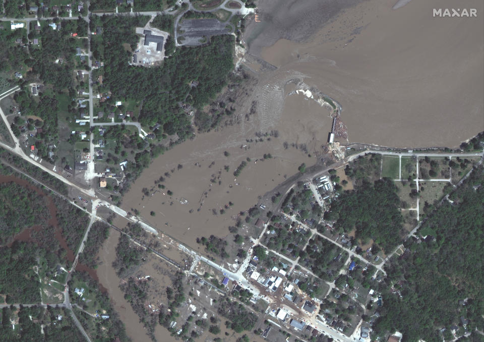 This photo provided by Maxar Technologies shows Sanford Dam in Sanford, Mich., Thursday, May 21, 2020, after it was damaged. (Maxar Technologies via AP)
