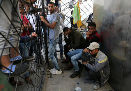 Palestinians react at a hospital following an explosion in the southern Gaza Strip, April 14, 2018. REUTERS/Ibraheem Abu Mustafa