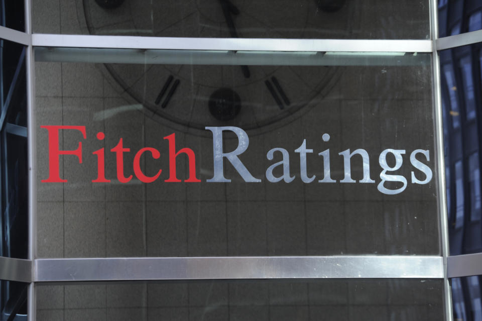 A Fitch Ratings sign is shown in glass.