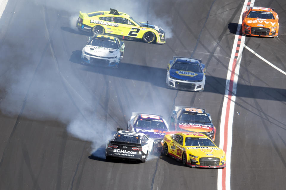 Joey Logano (22), Tyler Reddick (8), Denny Hamlin (11), Daniel Suarez (99) and Austin Cindric (2) crash during a NASCAR Cup Series auto race at Atlanta Motor Speedway in Hampton, Ga., Sunday, March 20, 2022. (AP Photo/Hakim Wright Sr.)