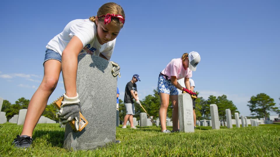 Volunteers scrub headstones and help with maintenance efforts at Houston National Cemetery Saturday, Sept. 10, 2022. - Brett Coomer/Houston Chronicle/Getty Images