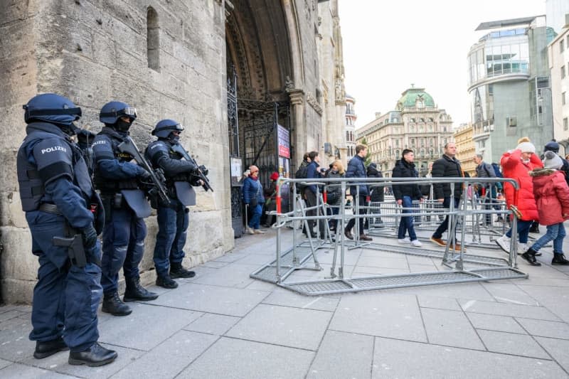 Police officers stand in front of St. Stephen's Cathedral following indications of a possible attack plan by a terrorist group. According to the Austrian Ministry of the Interior, the Austrian Office for the Protection of the Constitution has arrested four people in an investigation into a terrorist network. Max Slovencik/APA/dpa