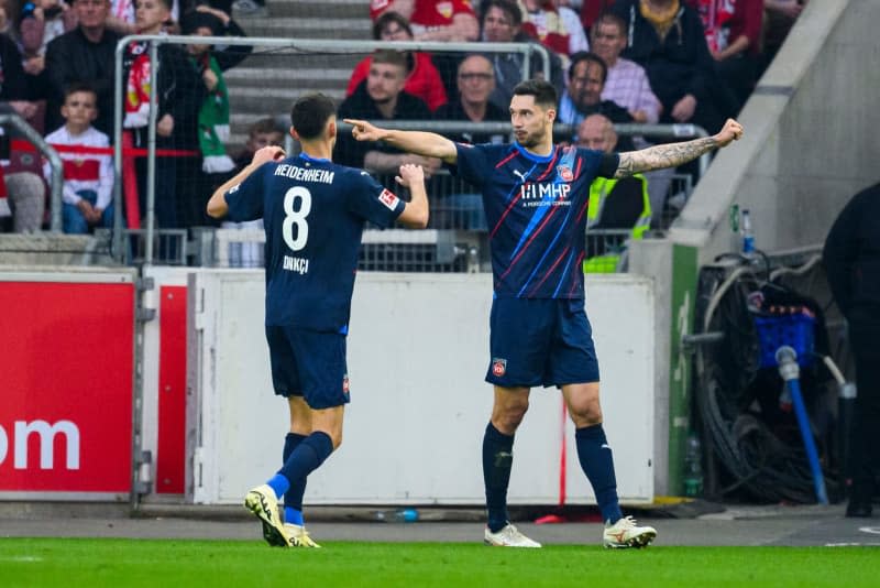 Heidenheim's Tim Kleindienst (R) celebrates with Heidenheim's Eren Dinkci after scoring his side's second goal during the German Bundesliga soccer match between VfB Stuttgart and 1. FC Heidenheim at MHPArena. Tom Weller/dpa