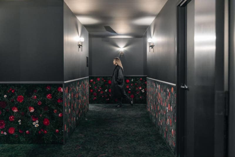 Gray carpet with red and pink roses, carpet up half wall to railing trim