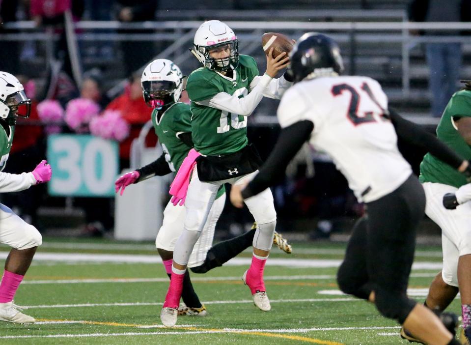 South Bend Washington quarterback Gabe Weber (18) handles a snap Friday, Oct. 13, 2023, at the John Glenn vs. South Bend Washington football game at School Field in South Bend.