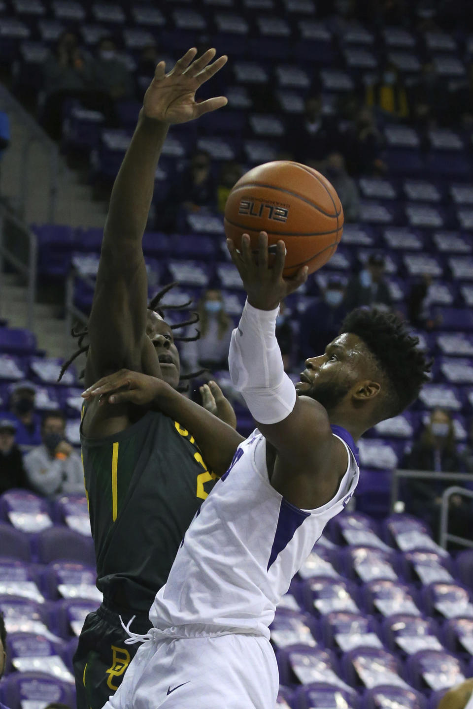 Baylor forward Jonathan Tchamwa Tchatchoua (23) tries to defend against a shot by TCU guard Mike Miles (1) in the first half of an NCAA college basketball game, Saturday, Jan. 9, 2021, in Fort Worth, Texas. (AP Photo/ Richard W. Rodriguez)