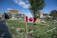 <p>A Canadian flag flies in front of homes destroyed by a tornado in Dunrobin, Ont., west of Ottawa, on Saturday, Sept. 22, 2018. The storm tore roofs off of homes, overturned cars and felled power lines in the Ottawa community of Dunrobin and in Gatineau, Que. (Photo from Justin Tang/The Canadian Press) </p>