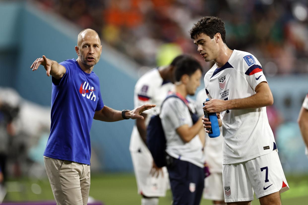 United States coach Gregg Berhalter gives instructions to Gio Reyna during a FIFA World Cup game against Netherlands on Dec. 3. (ANP via Getty Images)
