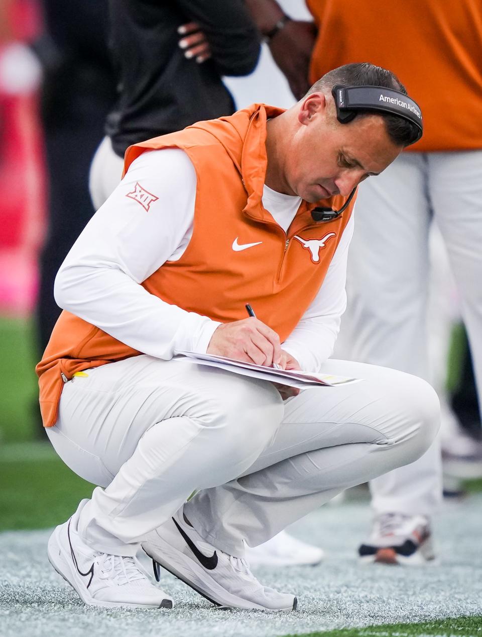 Texas head coach Steve Sarkisian writes notes during the fourth quarter of Saturday's 31-24 win over Houston. Several of his former BYU teammates told the American-Statesman that they're not surprised the former Cougars quarterback transitioned so well into coaching.
