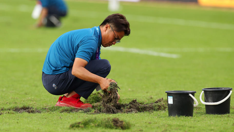 Grounds staff repair the pitch at half time during the Rugby World Cup 2019 Group B game between Italy and Canada at Fukuoka Hakatanomori Stadium on September 26, 2019 in Fukuoka, Japan. (Photo by Mark Kolbe/Getty Images)