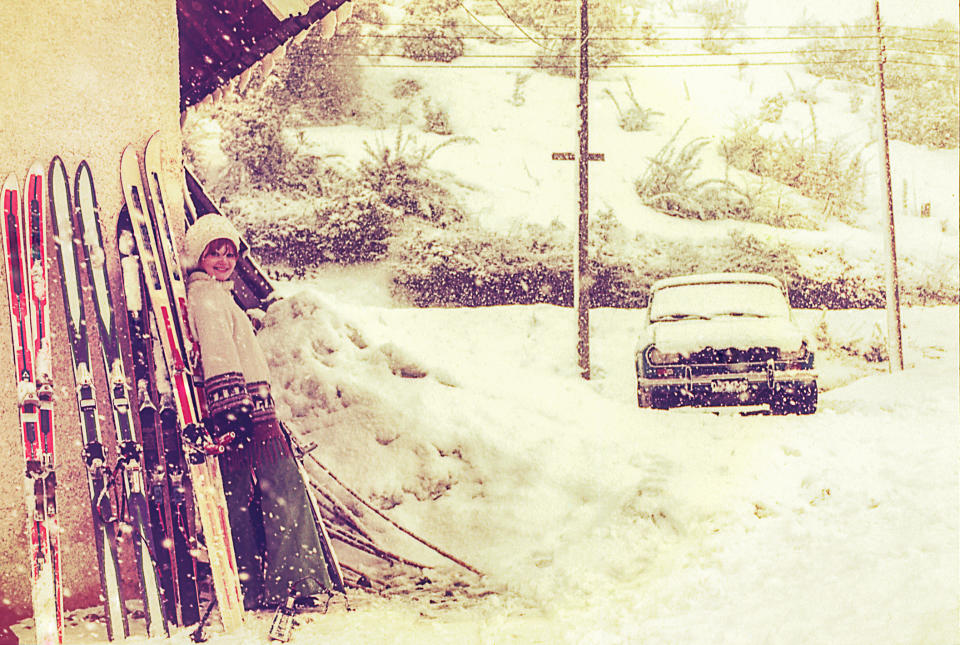 Woman with skis near a car