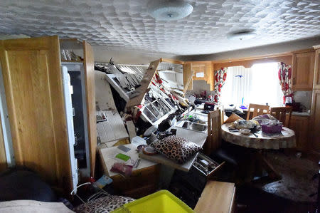 The kitchen of Bernie Kearney's destroyed home is seen, after a landslide carrying a boulder and her car (seen at the kitchen window) came through the house, during torrential rains in Urris, County Donegal, Ireland August 24, 2017. REUTERS/Clodagh Kilcoyne