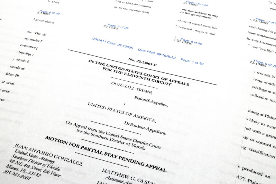 Pages from the Justice Department's motion to the 11th Circuit U.S. Court of Appeals in Atlanta are photographed Friday, Sept. 16, 2022. The Justice Department asked the federal appeals court to lift a judge's order that temporarily barred it from reviewing a batch of classified documents seized during an FBI search of former President Donald Trump's Florida home last month. (AP Photo/Jon Elswick)