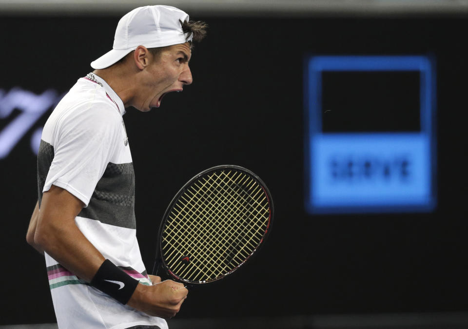 Australia's Alexei Popyrin celebrates after winning the third set tie break against France's Lucas Pouille during their third round match at the Australian Open tennis championships in Melbourne, Australia, Saturday, Jan. 19, 2019. (AP Photo/Kin Cheung)