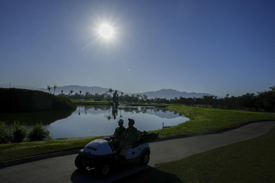 Groundworkers drive a cart during a practice round ahead of the Mexico Open golf tournament in Puerto Vallarta, Mexico, Wednesday, Feb. 21, 2024. (AP Photo/Fernando Llano)