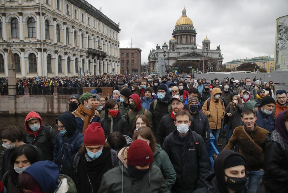 People walk during a protest in support of jailed opposition leader Alexei Navalny in St. Petersburg, Russia, Wednesday, April 21, 2021. Police across Russia have arrested more than 180 people in connection with demonstrations in support of imprisoned opposition leader Alexei Navalny, according to a human rights group. Navalny's team called the unsanctioned demonstrations for Wednesday after reports that his health is deteriorating while on hunger strike, which he began March 31. (AP Photo/Dmitri Lovetsky)