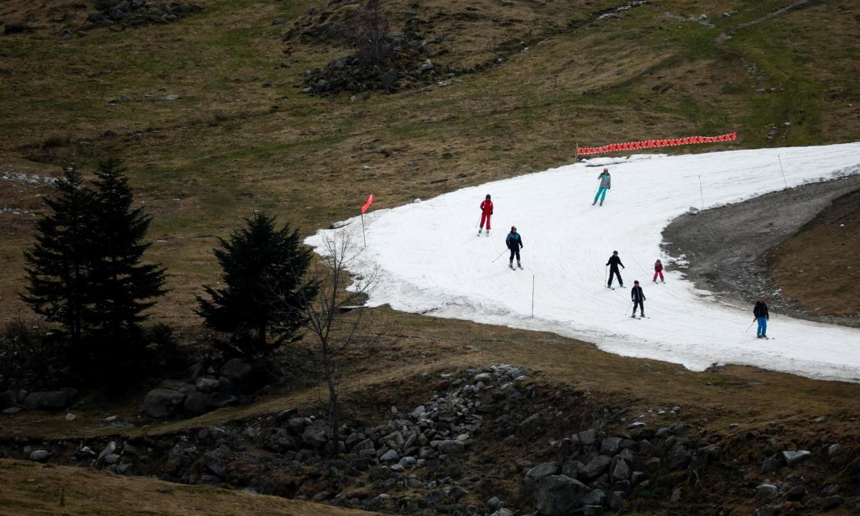 <span>Skiers pass on an artificial ski snow slope on a mild winter day in the Barèges ski resort, Hautes-Pyrenees, south-western France, this month.</span><span>Photograph: Stéphane Mahé/Reuters</span>