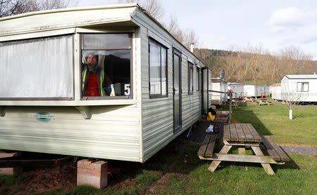 A Eastern European worker cleans a mobile home in the accommodation area at Cobrey Farm in Ross-on-Wye, Britain, March 11, 2019. Picture taken March 11, 2019. REUTERS/Peter Nicholls