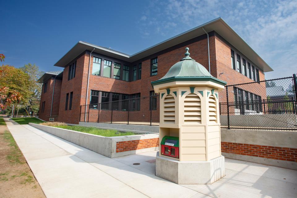 The former ventilation cupola from the old Edison Elementary School stands near the corner of the new building. The cupola now houses a Little Free Library and is surrounded by reclaimed bricks from the original school.
