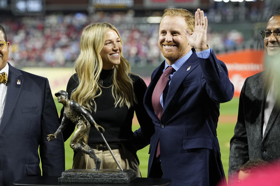 Los Angeles Dodgers player Justin Turner standing with his wife Courtney Turner receives the Roberto Clemente Award before Game 3 of baseball's World Series between the Houston Astros and the Philadelphia Phillies on Tuesday, Nov. 1, 2022, in Philadelphia. (AP Photo/David J. Phillip)