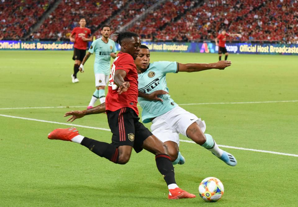Manchester United's Aaron Wan-Bissaka (red jersey) and Inter Milan's Dalbert tussle for the ball during their International Champions Cup match. (PHOTO: Zainal Yahya/Yahoo News Singapore)