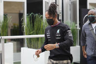 Mercedes driver Lewis Hamilton, of Britain, walks to a news conference before the Formula One U.S. Grand Prix auto race at Circuit of the Americas, Thursday, Oct. 21, 2021, in Austin, Texas. (AP Photo/Nick Didlick)