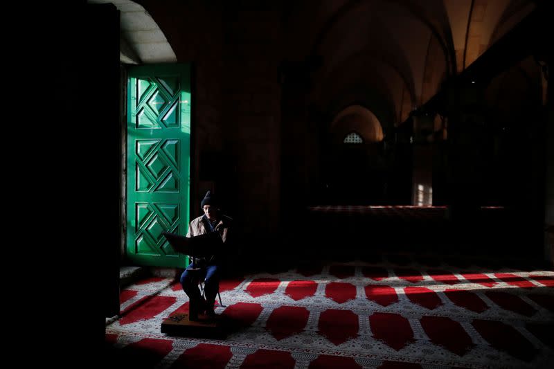 A man reads inside the al-Aqsa mosque on the compound known to Muslims as Noble Sanctuary and to Jews as Temple Mount, during their visit to Jerusalem's Old City