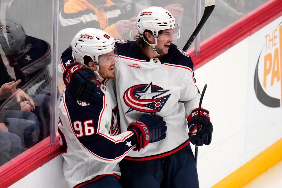 Columbus Blue Jackets' Jack Roslovic (96) celebrates with Andrew Peeke after scoring against the Pittsburgh Penguins during the third period of an NHL hockey game Tuesday, March 5, 2024, in Pittsburgh. (AP Photo/Gene J. Puskar)