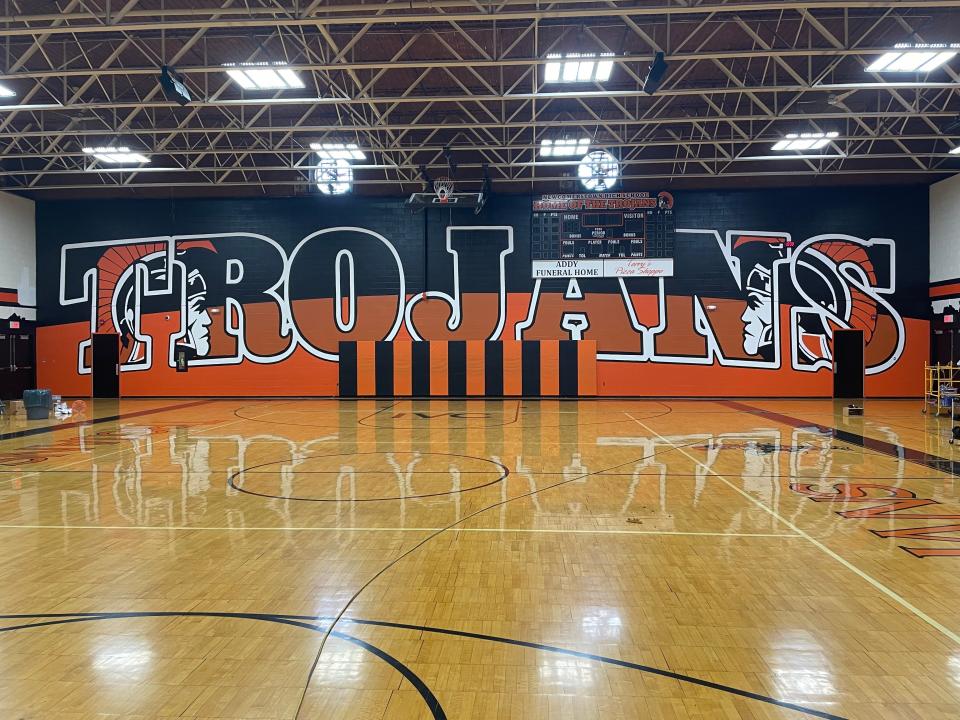 Scott Hagan, who's also known as "The Barn Artist," painted a mural at Newcomerstown High School that features 14-foot high letters and spans 100 feet.