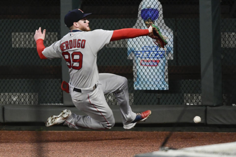 Boston Red Sox right fielder Alex Verdugo cannot catch a fly ball off the bat of Atlanta Braves' Adeiny Hechavarria during the eighth inning of a baseball game Friday, Sept. 25, 2020, in Atlanta. (AP Photo/John Amis)